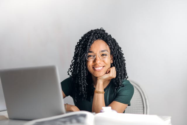 Smiling student while browsing her laptop